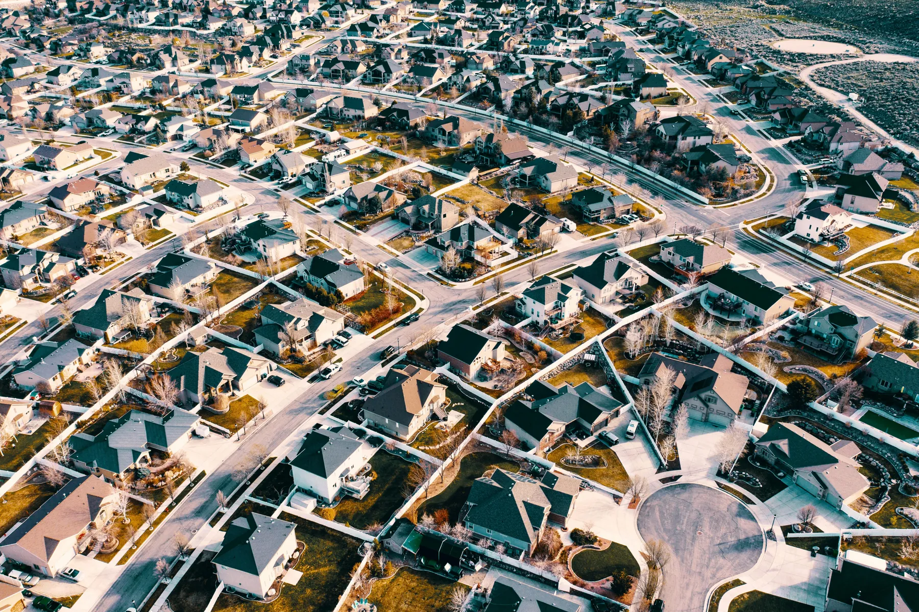Illustrative neighborhood aerial image representing residential stability and community